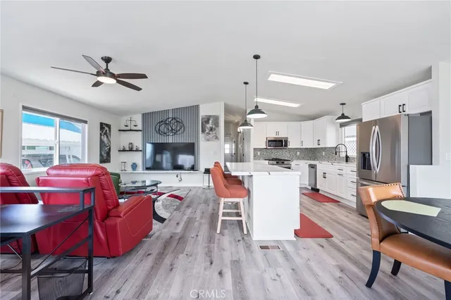 a living room with furniture and kitchen view