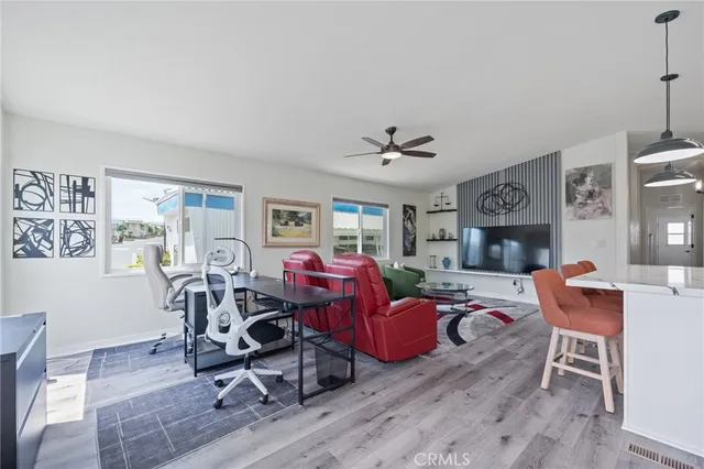 a living room with fireplace furniture and a wooden floor