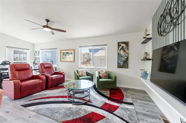 a living room with furniture a rug and a flat screen tv