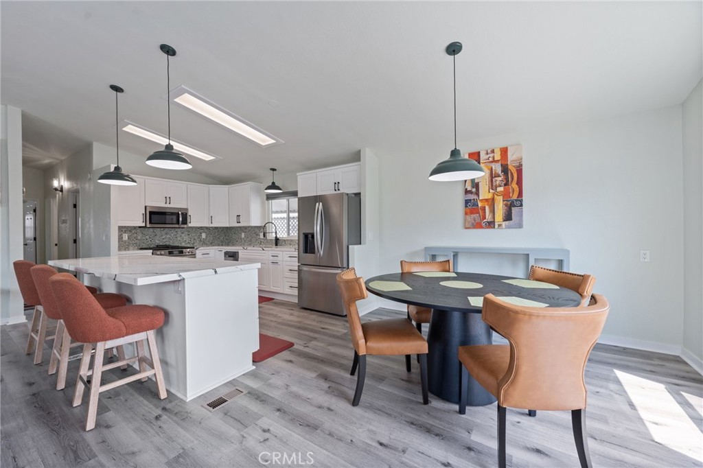 65 Hummingbird Lane Oceanside, CA 92057 - Photo 9 of 38 a view of a dining room with furniture and wooden floor