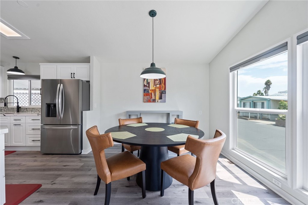 65 Hummingbird Lane Oceanside, CA 92057 - Photo 10 of 38 a dining room with furniture a chandelier and wooden floor