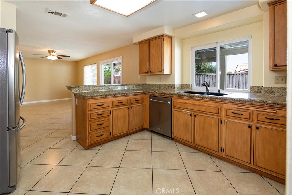 39203 Laurel Leaf Drive Murrieta, CA 92563 - Photo 12 of 59 a kitchen with stainless steel appliances granite countertop a sink and cabinets