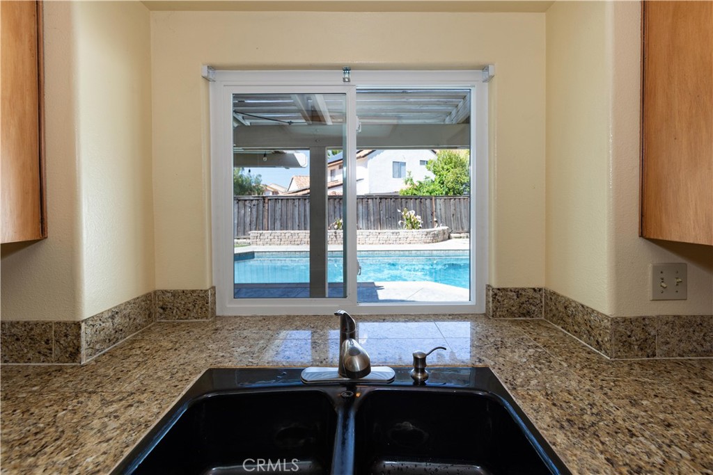 39203 Laurel Leaf Drive Murrieta, CA 92563 - Photo 15 of 59 a kitchen with a sink and a window
