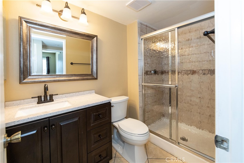 39203 Laurel Leaf Drive Murrieta, CA 92563 - Photo 19 of 59 a bathroom with a granite countertop sink mirror toilet and shower