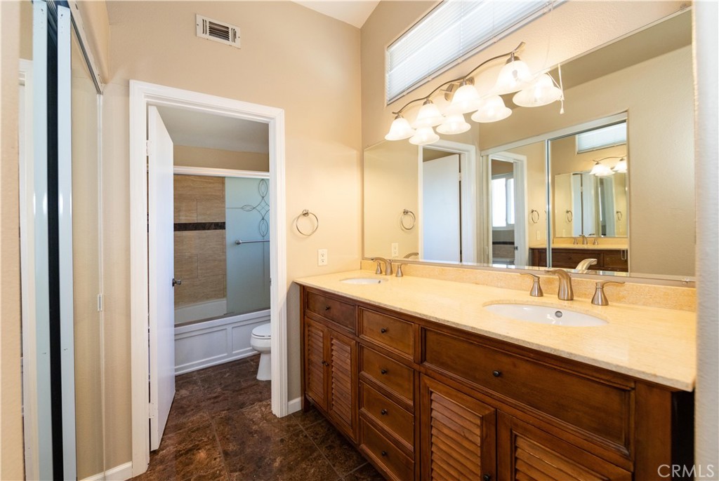 39203 Laurel Leaf Drive Murrieta, CA 92563 - Photo 25 of 59 a spacious bathroom with a double vanity sink and a mirror