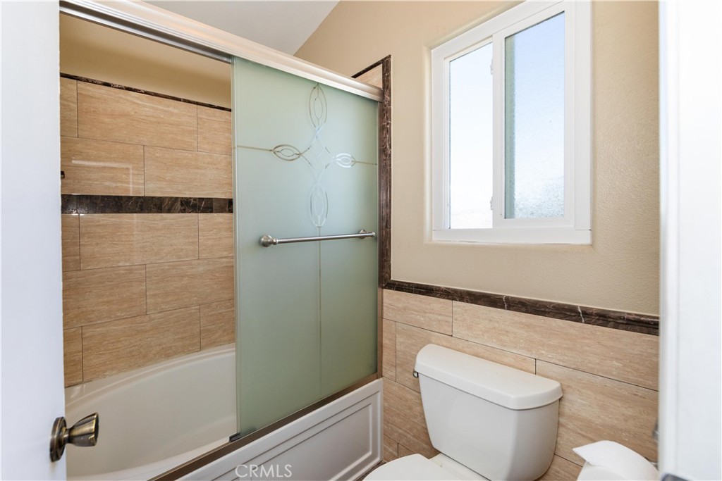 39203 Laurel Leaf Drive Murrieta, CA 92563 - Photo 26 of 59 a bathroom with a shower a toilet and a sink