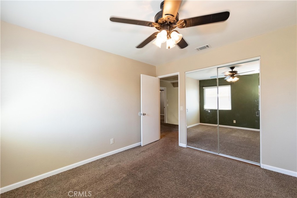39203 Laurel Leaf Drive Murrieta, CA 92563 - Photo 33 of 59 an empty room with a ceiling fan and a shower