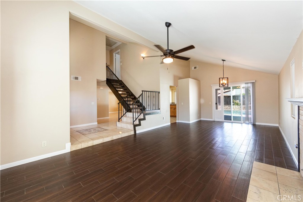 39203 Laurel Leaf Drive Murrieta, CA 92563 - Photo 4 of 59 a view of a livingroom with wooden floor staircase and a kitchen