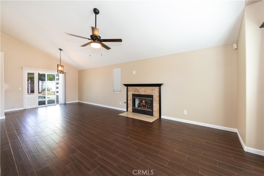 39203 Laurel Leaf Drive Murrieta, CA 92563 - Photo 5 of 59 a view of an empty room with wooden floor fireplace and a window