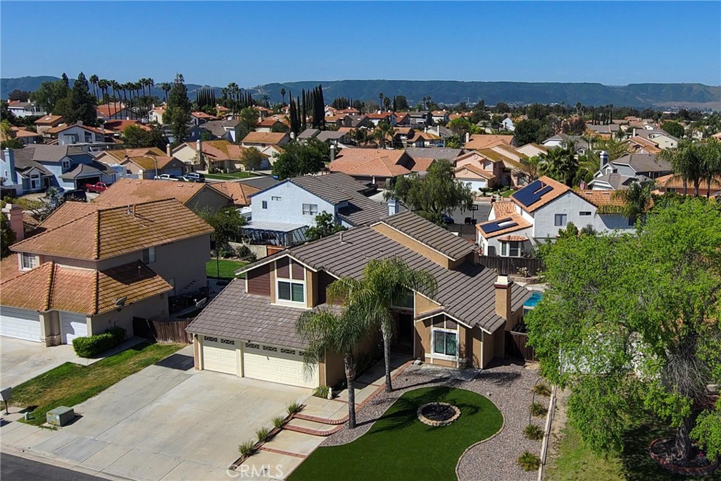 39203 Laurel Leaf Drive Murrieta, CA 92563 - Photo 54 of 59 an aerial view of multiple houses with a swimming pool