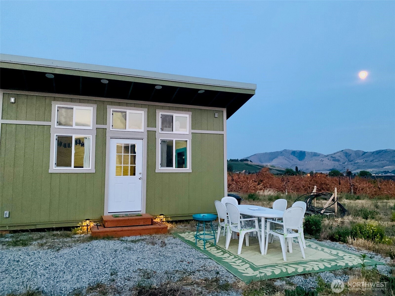 127 Hurley Lane Manson, WA 98831 - Photo 2 of 29 a backyard of a house with table and chairs