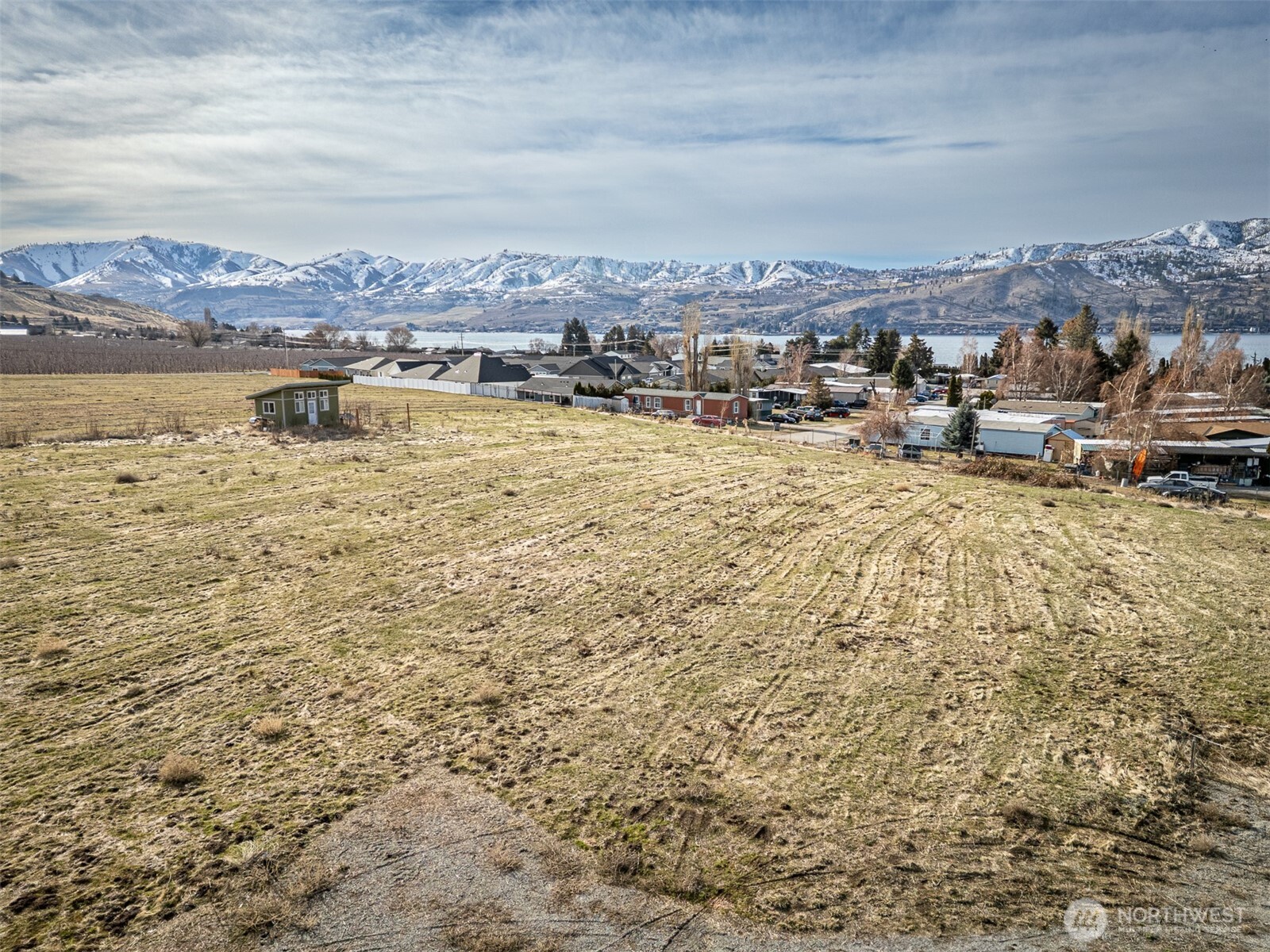 127 Hurley Lane Manson, WA 98831 - Photo 28 of 29 a view of a lake with houses in the back