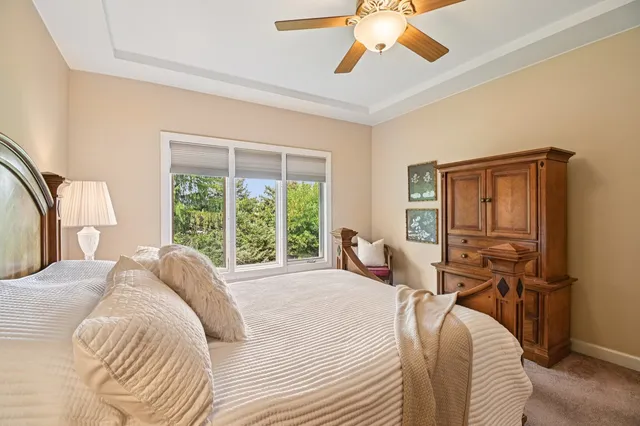 a bedroom with a bed and a large window