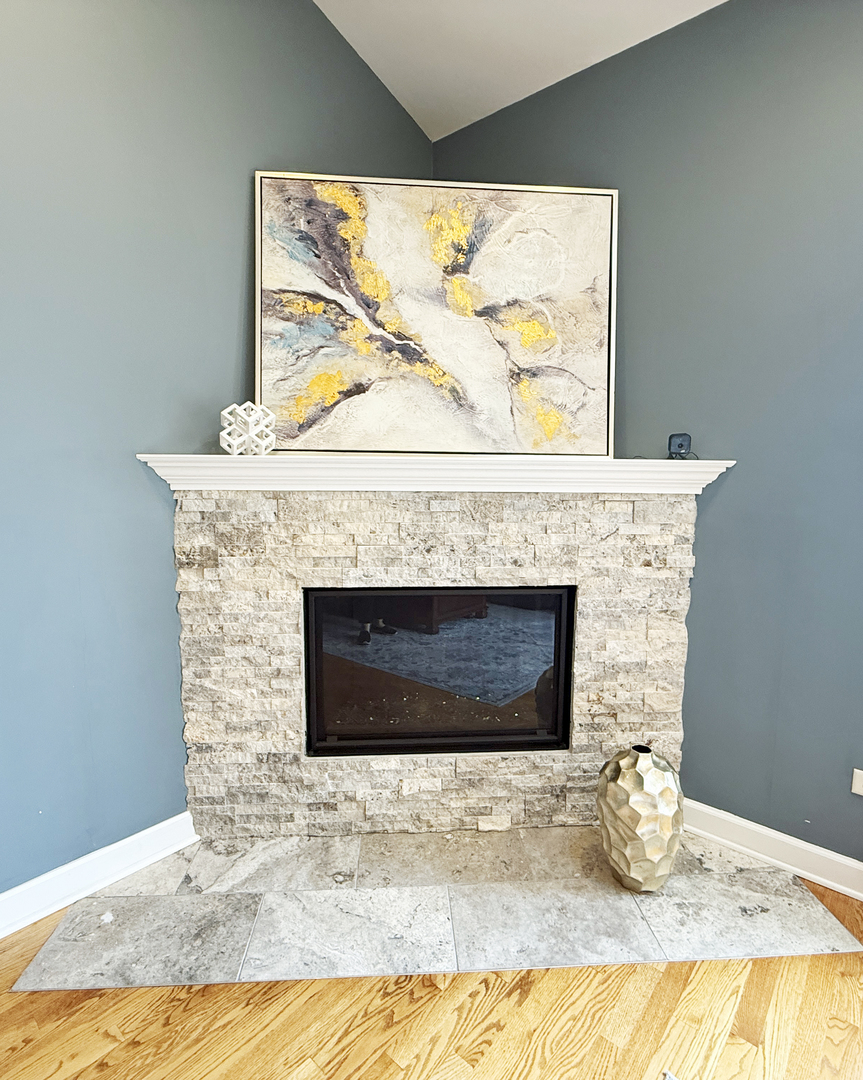 4N466 Mark Twain Street St. Charles, IL 60175 - Photo 7 of 36 a bedroom with a fireplace and wooden floor