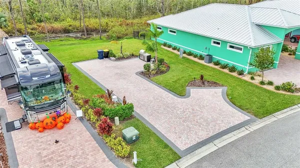 an aerial view of a house with a yard