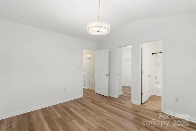 a view of a room with wooden floor