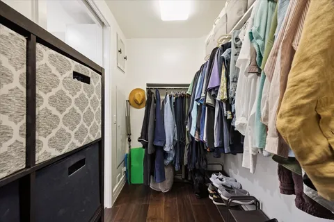 a view of walk in closet with clothes