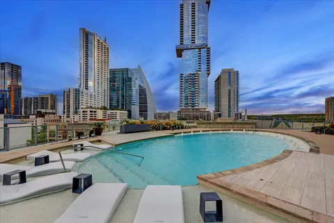 a living room with patio furniture and a floor to ceiling window