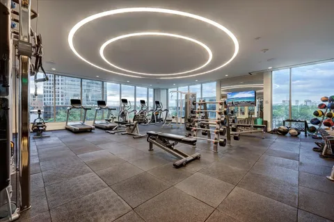 a view of kitchen with kitchen island microwave and view living room