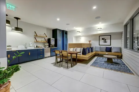 a view of a dining room with furniture and a large window