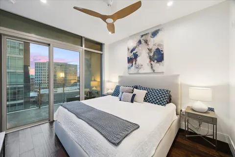 a bedroom with a large bed and a window