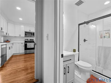 a bathroom with a toilet a sink and a shower