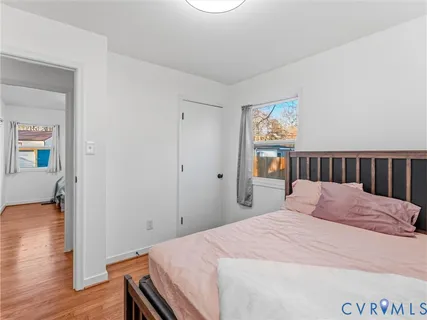 a bedroom with a bed and wooden floor