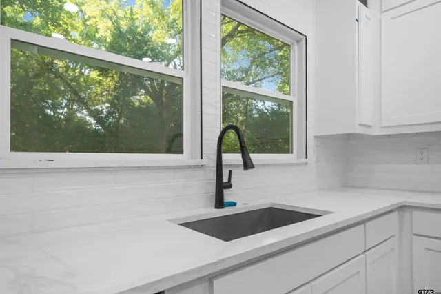 a kitchen with a sink and large window