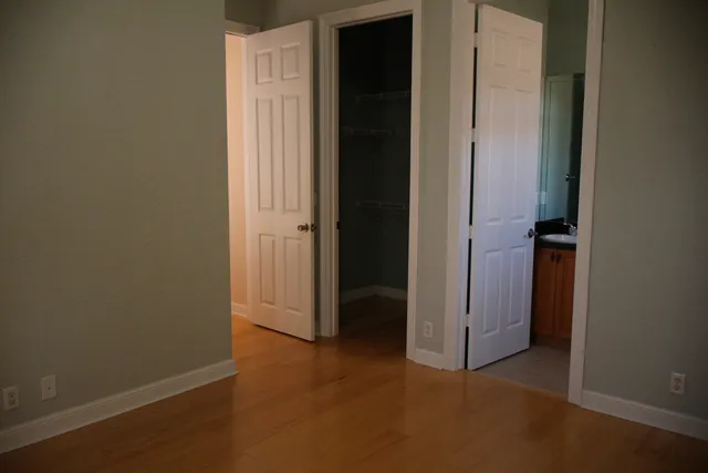 a white toilet sitting next to a shower