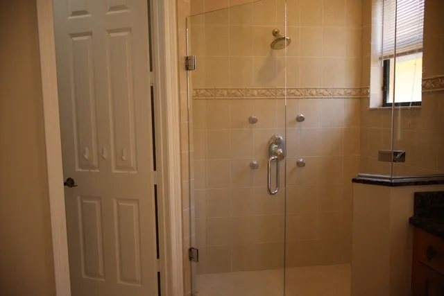 a view of a bathroom with a window and a white door