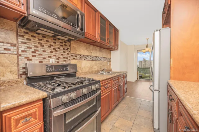 a kitchen with granite countertop a stove and a sink