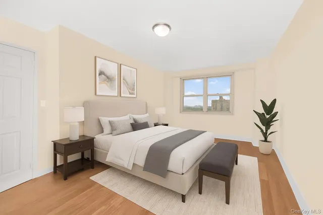 a bedroom with a bed and a potted plant