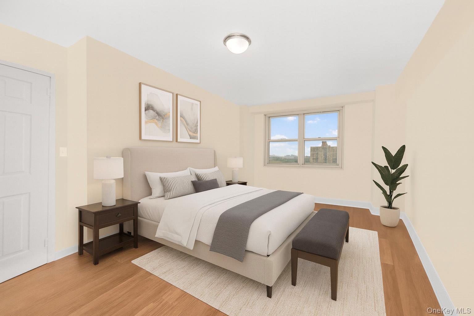 880 Boynton Avenue, Unit 13L Bronx, NY 10473 - Photo 6 of 19 a bedroom with a bed and a potted plant