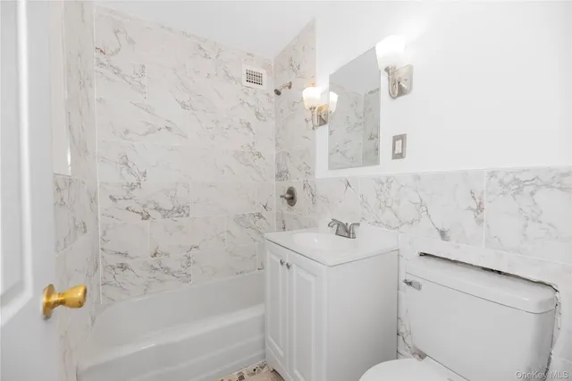 a bathroom with a sink a toilet and bathtub