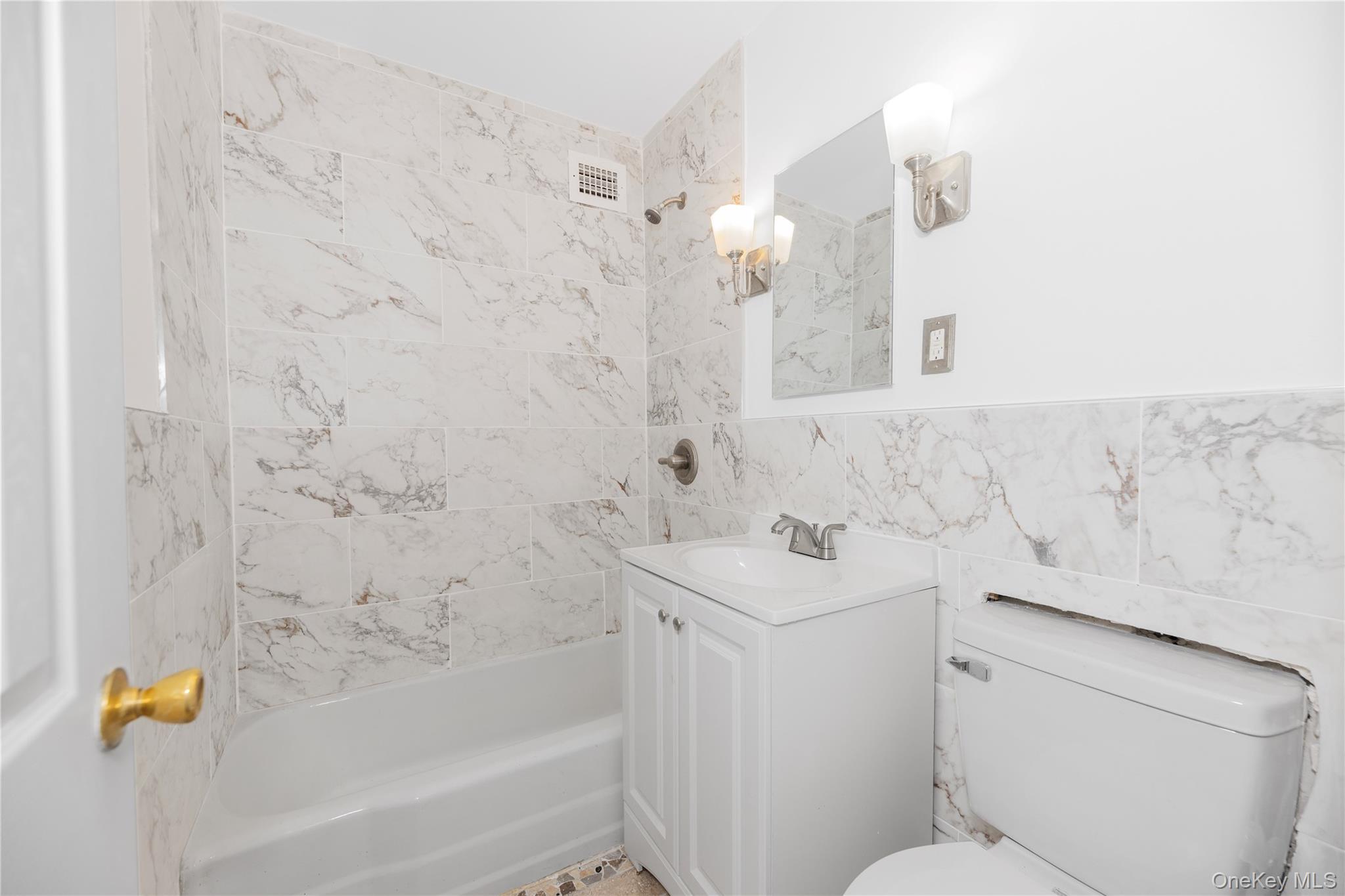 880 Boynton Avenue, Unit 13L Bronx, NY 10473 - Photo 8 of 19 a bathroom with a sink a toilet and bathtub