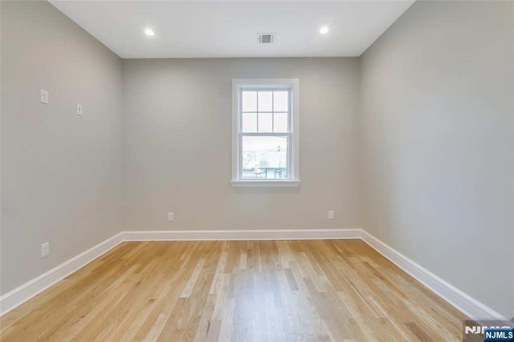 7 Hawthorne Avenue, Unit 7A Park Ridge, NJ 07656 - Photo 11 of 13 a view of empty room with wooden floor and fan