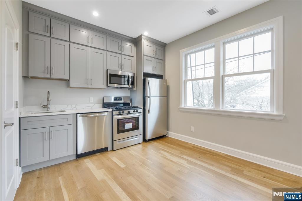 7 Hawthorne Avenue, Unit 7A Park Ridge, NJ 07656 - Photo 4 of 13 a kitchen with stainless steel appliances granite countertop a stove a sink and a refrigerator