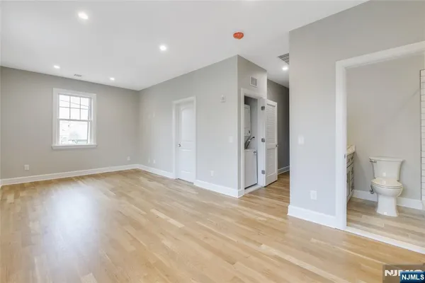 a view of a room with wooden floor and a window