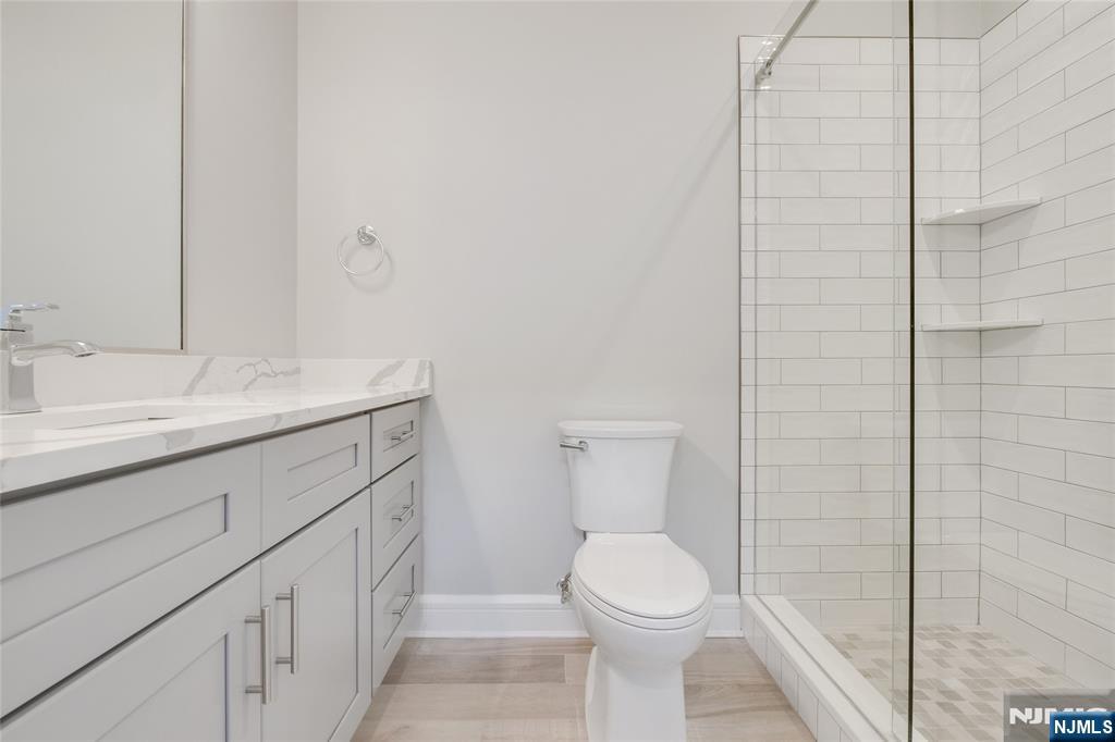 7 Hawthorne Avenue, Unit 7A Park Ridge, NJ 07656 - Photo 8 of 13 a bathroom with a sink a toilet and shower
