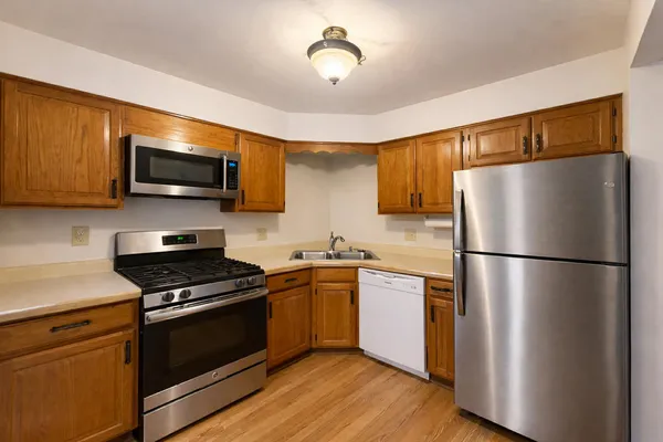 a kitchen with stainless steel appliances a refrigerator stove and microwave
