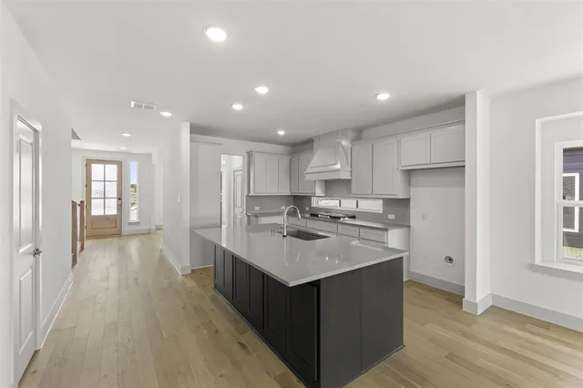 a kitchen with a sink stove and refrigerator