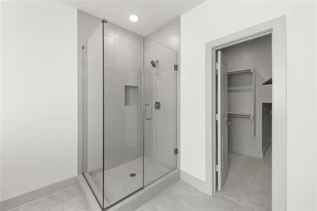a bathroom with a glass shower door