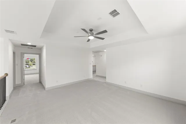 an empty room with closet and ceiling fan