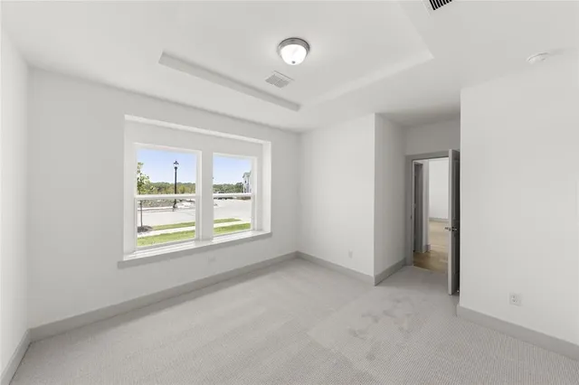 an empty room with windows and closet