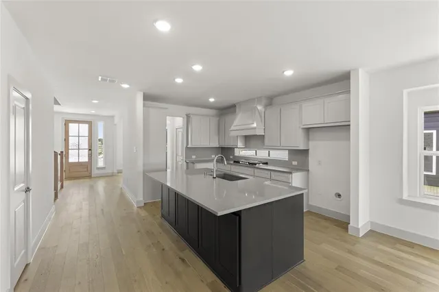 a kitchen with a sink stove and refrigerator