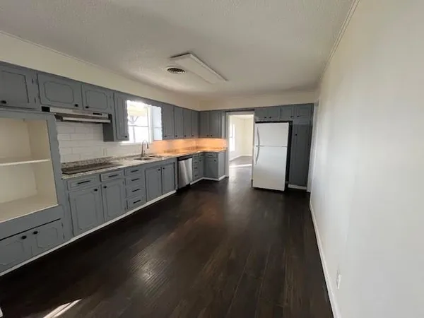 a kitchen with stainless steel appliances a refrigerator sink and cabinets