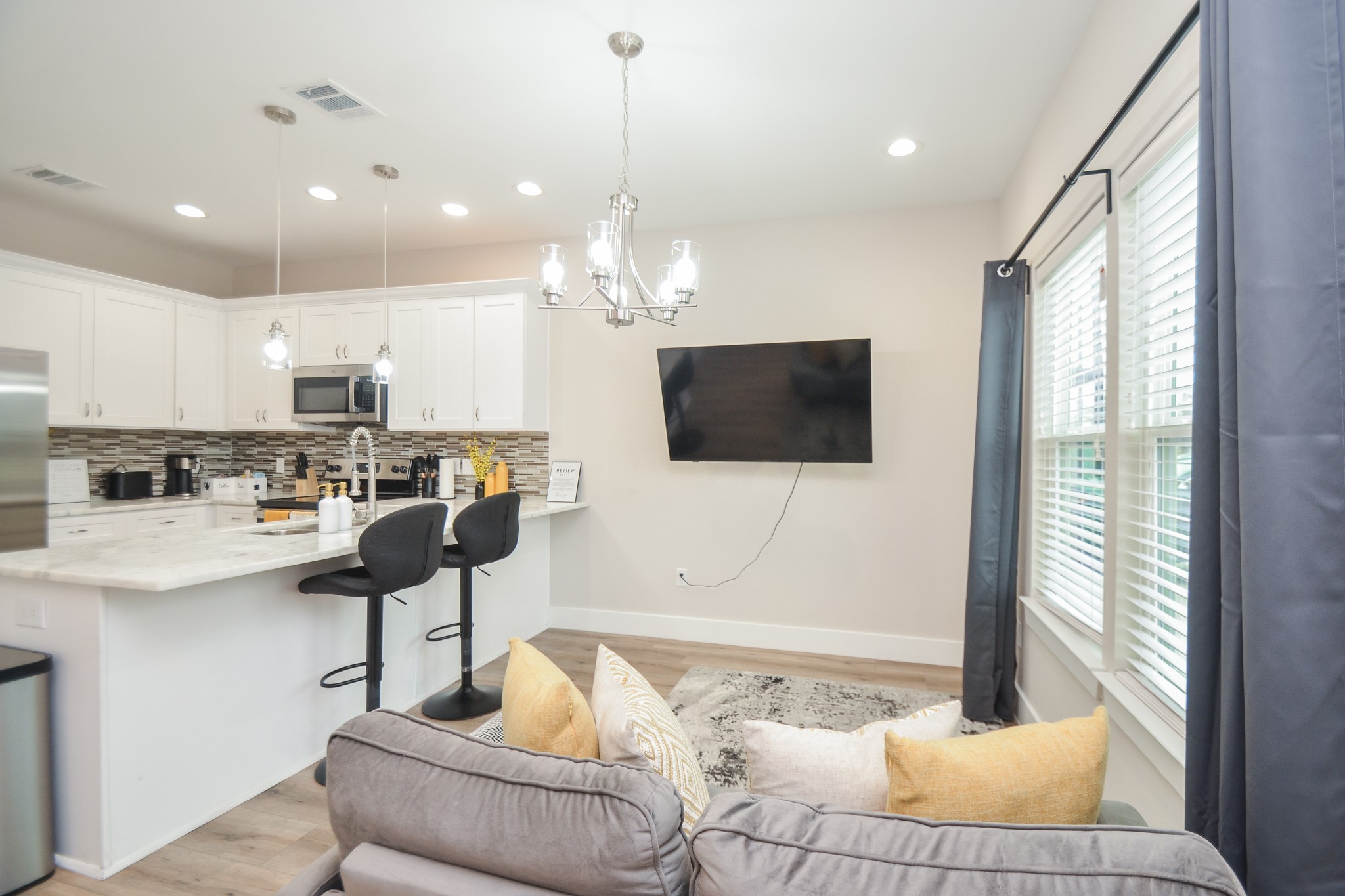 4511 Reed Road Houston, TX 77051 - Photo 11 of 39 a living room with kitchen furniture and a flat screen tv
