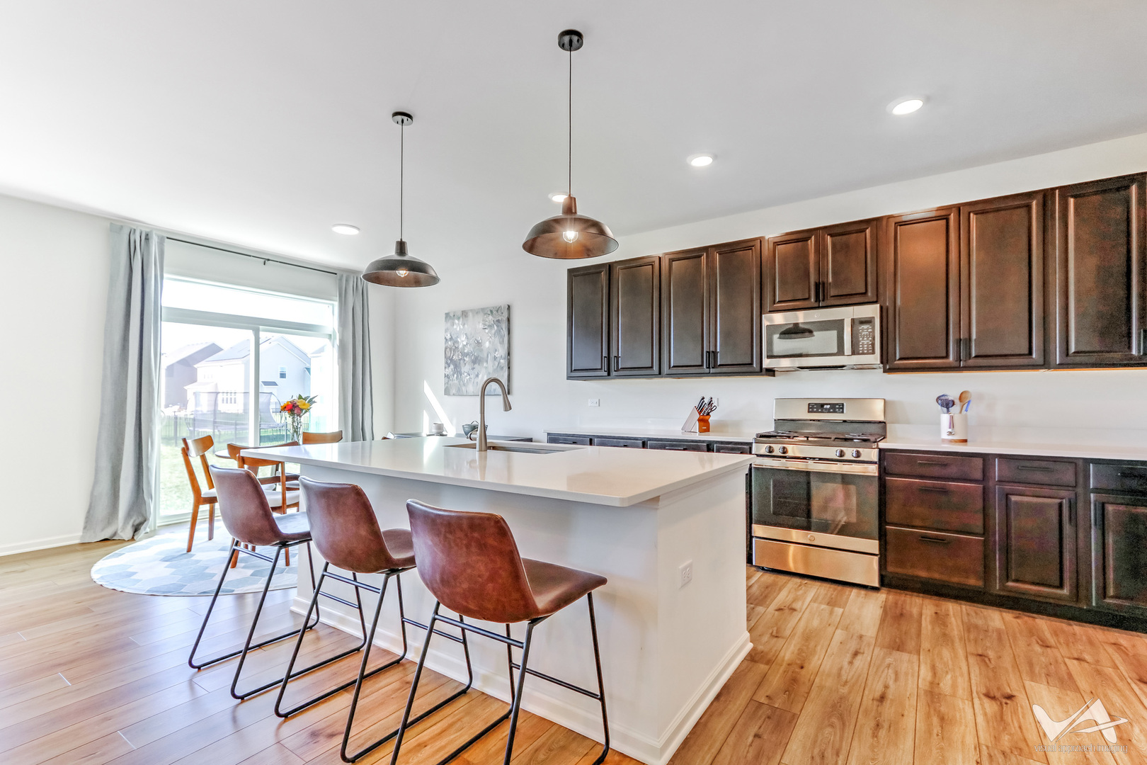 1828 Coralito Lane Elgin, IL 60124 - Photo 15 of 65 a kitchen with stainless steel appliances granite countertop wooden cabinets a stove a sink a dining table and chairs