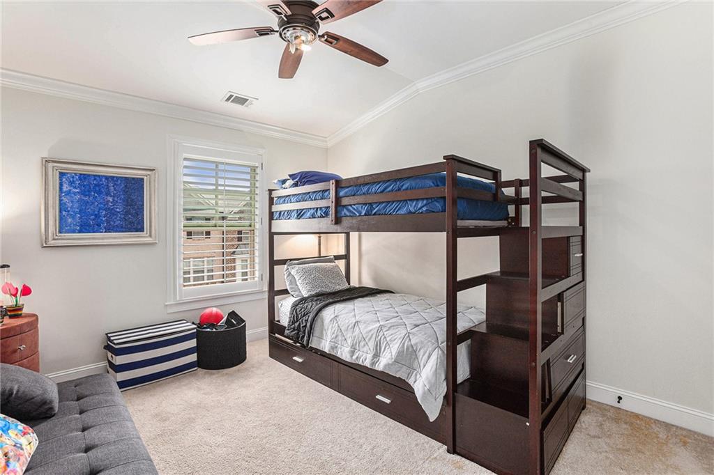 1438 Druid Manor Boulevard Atlanta, GA 30329 - Photo 22 of 31 a bedroom with a bed and a chandelier