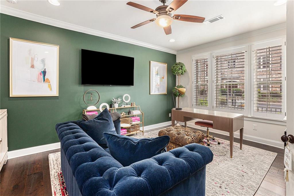 1438 Druid Manor Boulevard Atlanta, GA 30329 - Photo 23 of 31 a living room with furniture a flat screen tv and a large window
